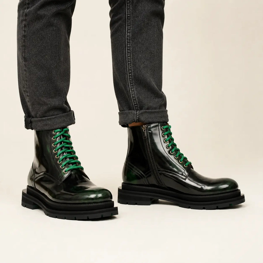 Green-black polished lace-up boots on-foot studio photo