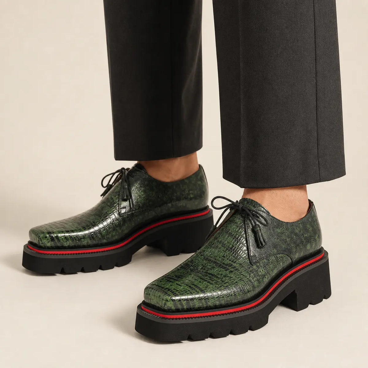 Green lizard leather Derby with elevated sole worn with charcoal wide-leg trousers