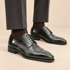 Dark green calfskin wingtip Derby shoes with glossy finish on model