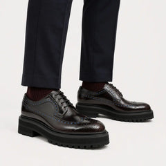Midnight burnished wingtip lug Derby shoes on foot