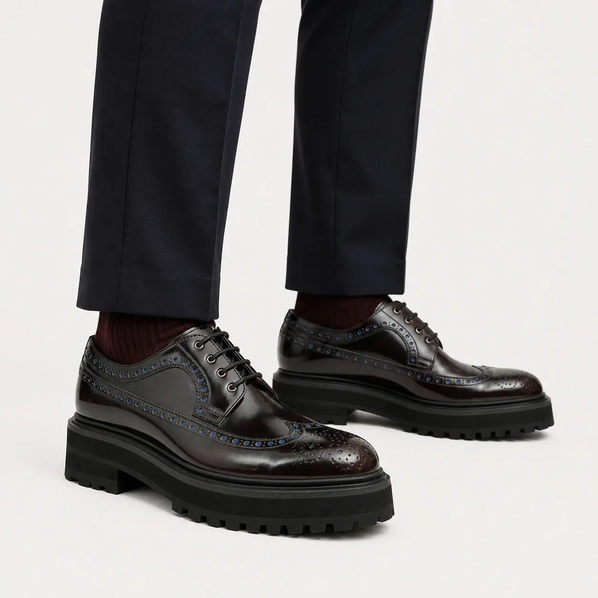 Midnight burnished wingtip lug Derby shoes on foot