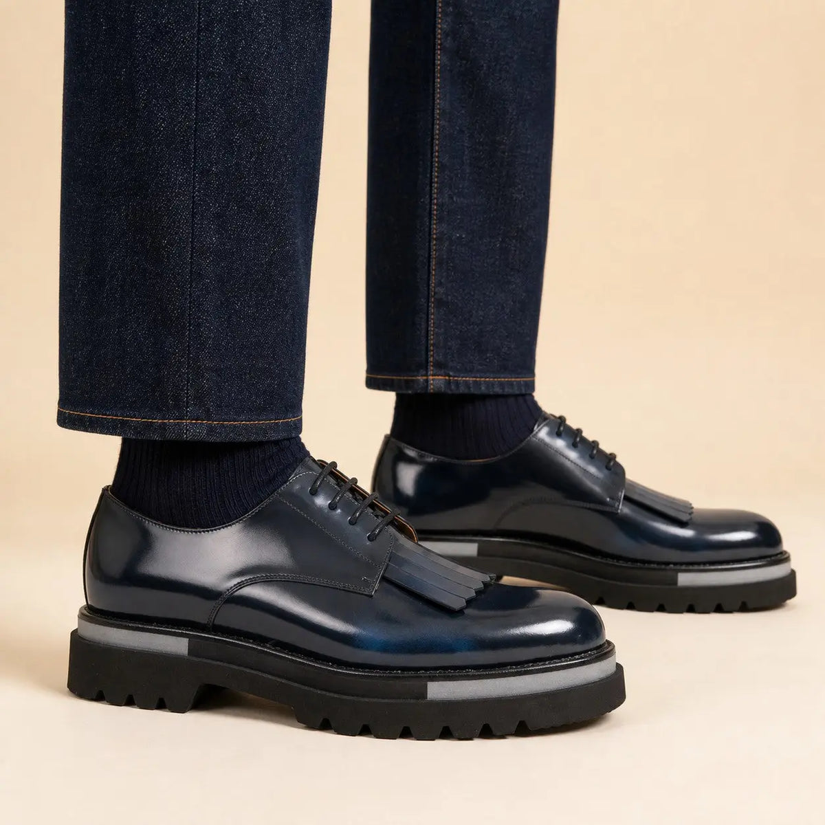 Navy blue patina kiltie Derby shoes on foot