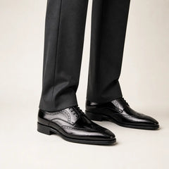 Polished Black Calf Derby on foot, warm off-white studio