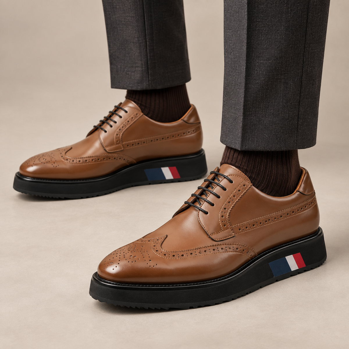 Tan brown platform wingtip Derby shoes — premium on-foot studio view