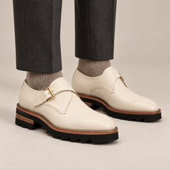 Ivory-white single monk shoes with gold-tone buckle — premium on-foot studio view